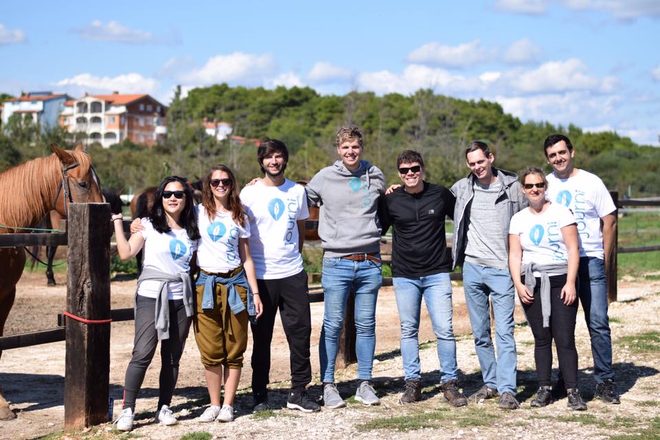 Bruno with Journi team posing for a team picture in a hourse riding school during a team retreat in Croatia